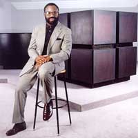 Philip Emeagwali sits in front of the Connection Machine with which he made his record-breaking 3.1 billion per second calculation that changed the global oil industry.